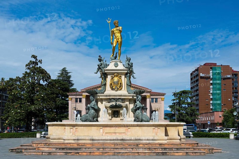 A fountain with a golden Neptune statue surrounded by water figures in front of a building, Neptune Fountain, Theatre Square, Batumi, Black Sea, Ajara region, Adjara, Autonomous Republic, Georgia