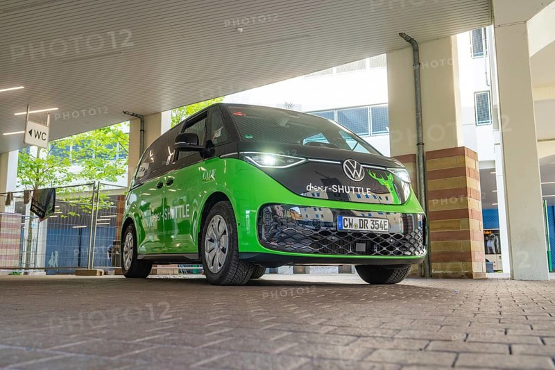 VW vehicle under a covered area in urban architecture, Deer E-Mobility Shuttle Service, Calw, Germany