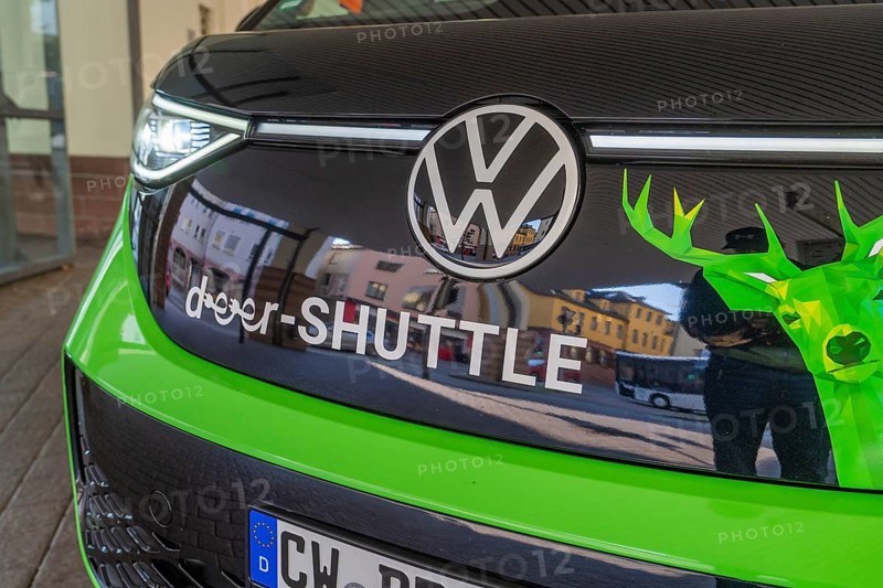 Close-up of the front part of a VW with green-black colors, Deer E-Mobility Shuttle Service, Calw, Germany