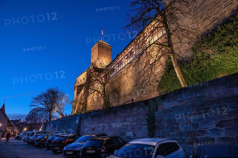 Nuremberg Kaiserburg in evening lighting, blue evening sky, cars parked below on the castle wall, Ölberg, Nuremberg, Mittelfranlen, Bavaria, Germany