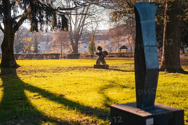 Sculptures on a sunny green area in the park in autumn, Stadtgarten Pforzheim, Germany