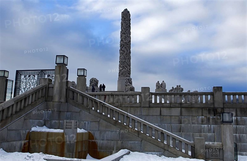 Monolith and statues on snowy stairs, cold winter atmosphere, Vigeland sculpture park Oslo Norway