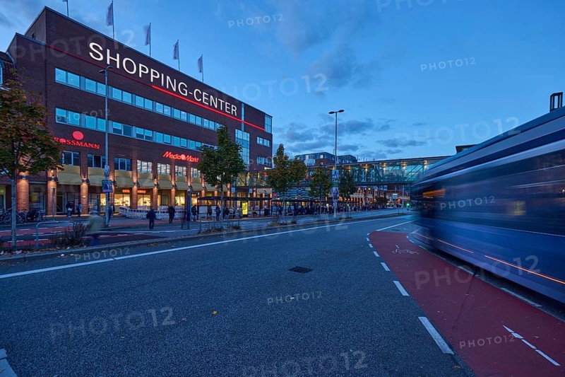 Sophienhof Kiel shopping center, modern architecture, brick building, commercial building, lantern, public bus, motion blur, light trails, cycle path, road, road marking cycle path, pedestrian as accessories, evening blue hour, blue evening sky, cumulus clouds, Sophienblatt, Kiel, state capital, district-free city, Schleswig-Holstein, Germany