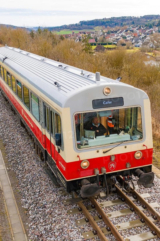 Side view of a moving train on the rails with an urban landscape in the background, historic event, first test run with a passenger train on the Hermann tracks, Hesse Railway since 1988, Calw district, Germany