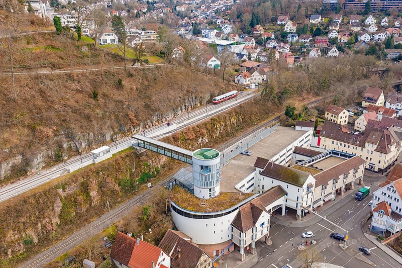 A city view with a train on the rails, surrounded by various buildings and a valley, historical event, first test run with a passenger train on the Hermann tracks, Hesse Railway since 1988, Calw, Calw district, Germany