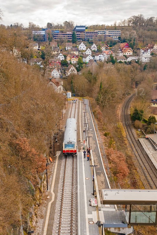 A train stops at a station on a hill with a view of a town with many buildings, historic event, first test run with a passenger train on the Hermann tracks, Hesse Railway since 1988, Calw, Calw district, Germany