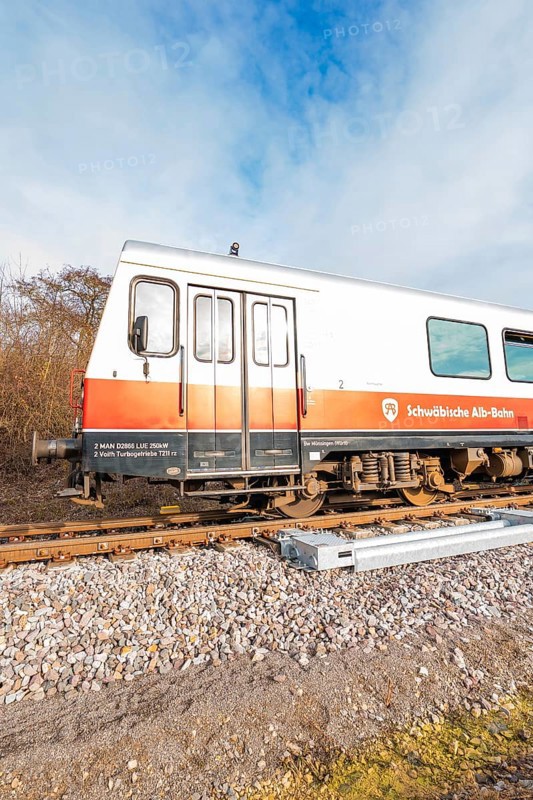 A train on rails under a blue sky with inscriptions visible on the wagons, historic event, first test run with a passenger train on the Hermann tracks, Hesse Railway since 1988, Calw district, Germany