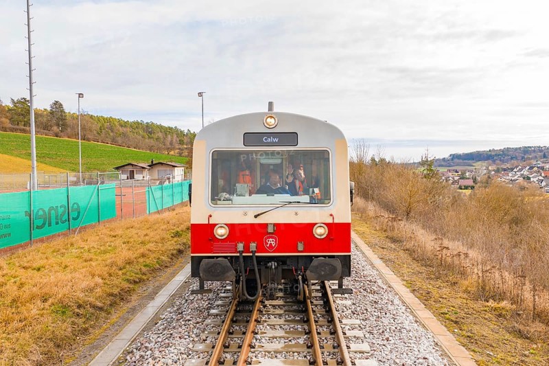 Train with passengers and the inscription 'Calw' on the rails, with landscape in the background, historic event, first test run with a passenger train on the Hermann tracks, Hesse Railway since 1988, Calw district, Germany