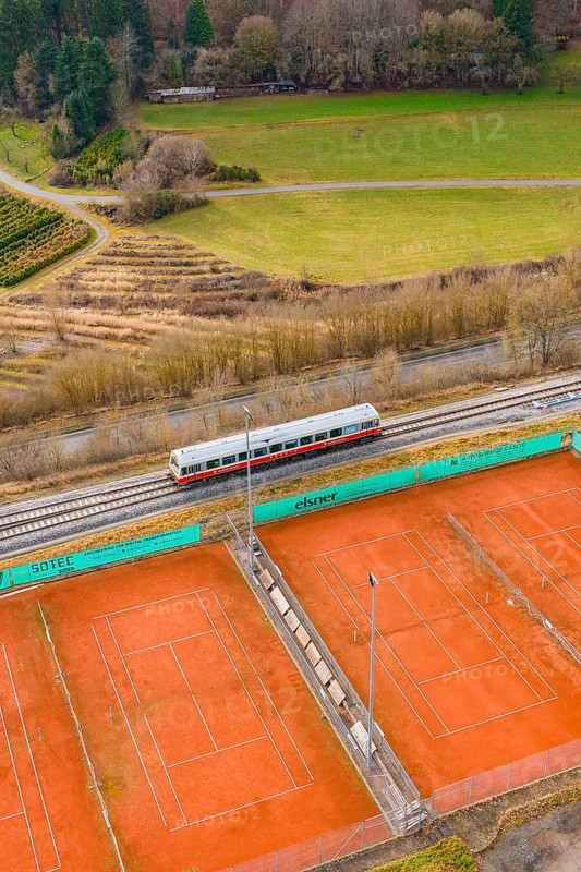 Landscape view with train next to tennis courts and meadows, historic event, first test run with passenger train on the Hermann tracks, Hesse Railway since 1988, Ostelsheim, Calw district, Germany