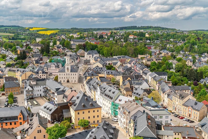 View from St. Wolfgang church of the town of Schneeberg with historic houses and town hall, Ore Mountains, Saxony, Germany