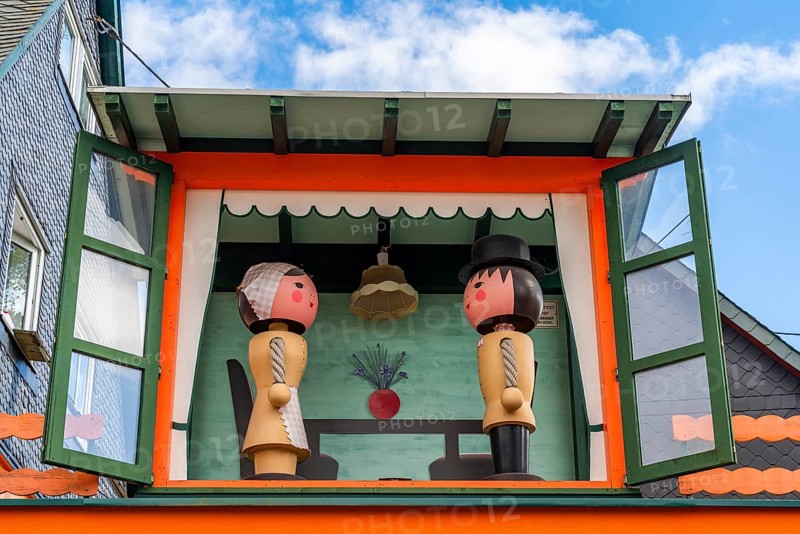 Two large wooden figures of man and woman in a small house, health resort and toy village Seiffen, Ore Mountains, Saxony, Germany