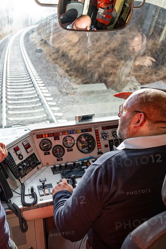 Train driver steers the train from a modern cockpit while traveling on rails, historic event, first test run with a passenger train on the Hermann tracks, Hesse Railway since 1988, Calw district, Germany