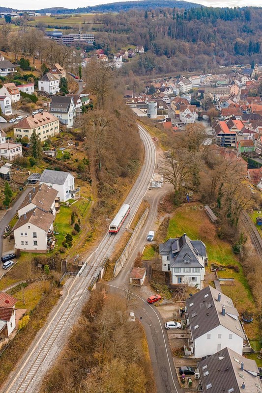 Train through suburban area with nearby houses and a wooded landscape, historic event, first test run with a passenger train on the Hermann tracks, Hesse Railway since 1988, Calw, Calw district, Germany