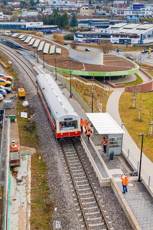 People standing on a platform next to a stopping train in an urban environment, historic event, first test run with a passenger train on the Hermann tracks, Hesse Railway since 1988, Calw, Heumaden, Calw district, Germany