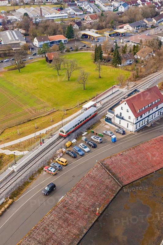 A train at a train station in an urban area with parked cars, historic event, first test run with a passenger train on the Hermann tracks, Hesse railway since 1988, Calw, Heumaden, Calw district, Germany