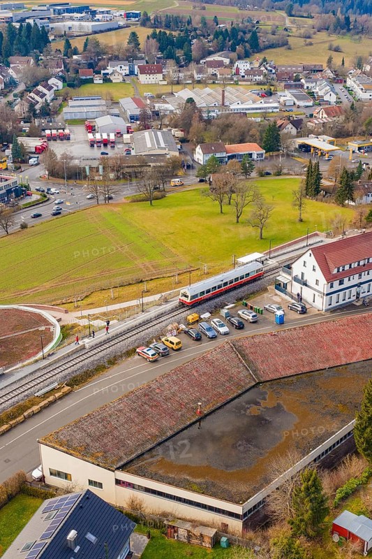 A train stops at a train station in a small town area with residential buildings, historic event, first test run with a passenger train on the Hermann tracks, Hesse railway since 1988, Calw, Heumaden, Calw district, Germany