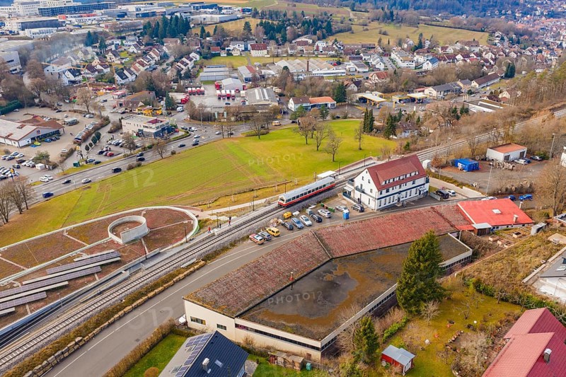 A train at a large train station, surrounded by residential buildings and roads, historic event, first test run with a passenger train on the Hermann tracks, Hesse Railway since 1988, Calw, Heumaden, Calw district, Germany