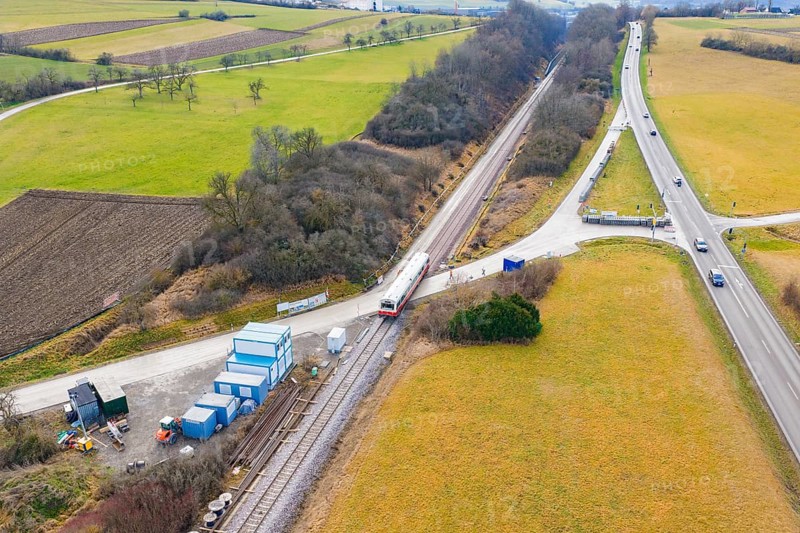 A rural scene with a train on rails, surrounded by fields and roads, historic event, first test run with a passenger train on the Hermann tracks, Hesse Railway since 1988, Calw district, Germany