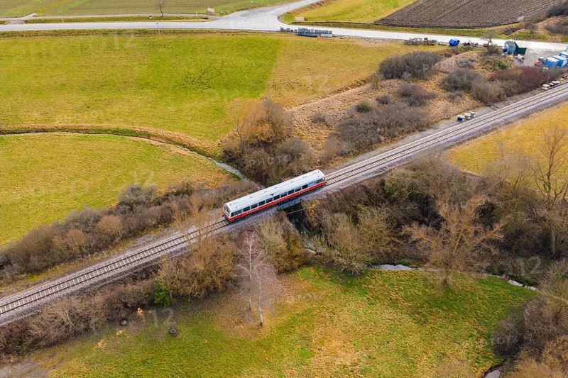 Train crosses a scenic bridge between winter fields and trees, historic event, first test run with a passenger train on the Hermann tracks, Hesse Railway since 1988, Calw district, Germany