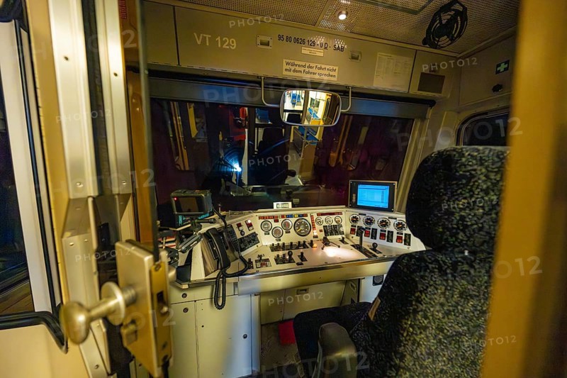 Interior view of a dark train driver's cab at night with illuminated control panel and technical displays, historic event, first test run with a passenger train on the Hermann tracks, Hesse Railway since 1988, Calw district, Germany
