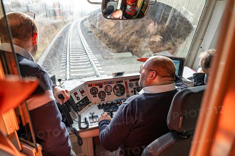 Team in the driver's cab of a train, looking at the railway tracks in front of them, historic event, first test run with a passenger train on the Hermann tracks, Hesse Railway since 1988, Calw district, Germany