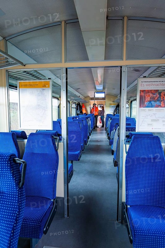 Interior of a train with blue seats and windows through which daylight enters, historic event, first test run with a passenger train on the Hermann tracks, Hesse Railway since 1988, Calw district, Germany