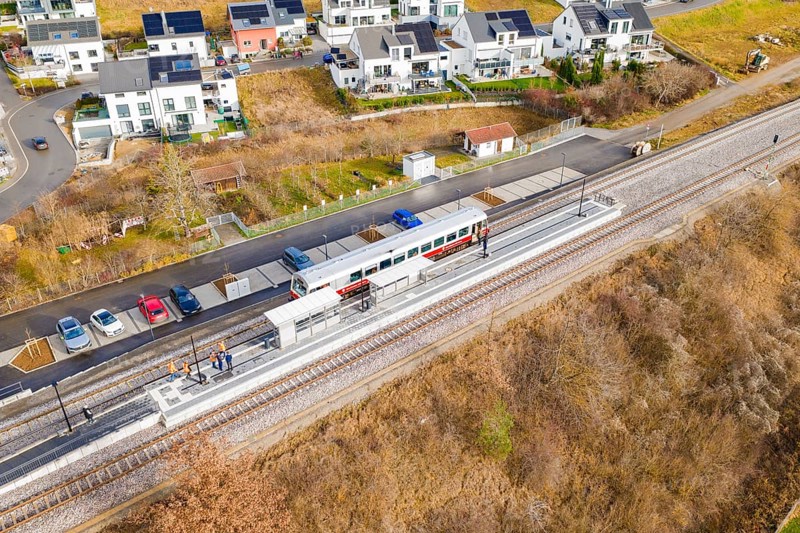 Small train stops at a railway stop within a residential development, historic event, first test run with a passenger train on the Hermann tracks, Hesse Railway since 1988, Ostelsheim, Calw district, Germany