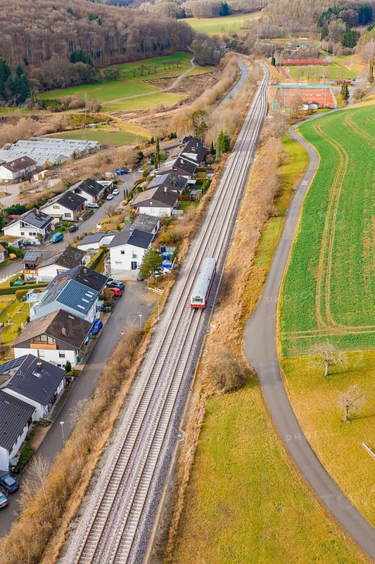 Station on a bend, surrounded by trees and fields near a settlement, historic event, first test run with a passenger train on the Hermann tracks, Hesse railway since 1988, Ostelsheim, Calw district, Germany