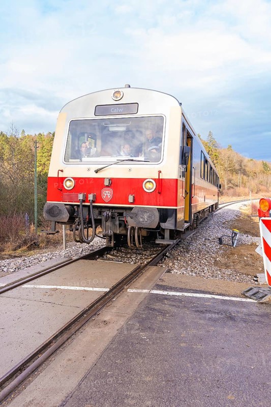 Train travels on rails through a landscape, past the railway signal, with cloudy sky, historic event, first test run with a passenger train on the Hermann tracks, Hesse Railway since 1988, Calw district, Germany