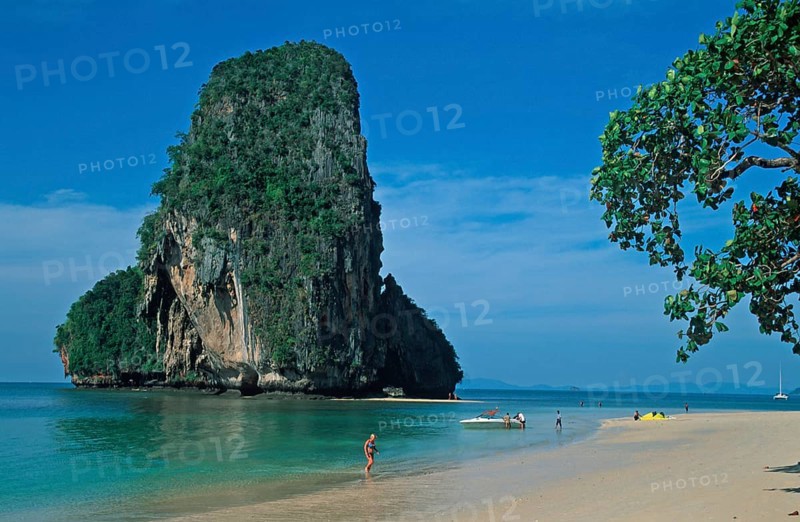 Rocks in the sea, tree, boat and people on Pranang Cave beach, two years in front of the tsunami, Krabi, Thailand, December 2002, vintage, retro, old, historic