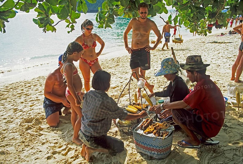 Woman with food store and customers on Pranang Cave beach, two years in front of the tsunami, Krabi, Thailand, December 2002, vintage, retro, old, historic