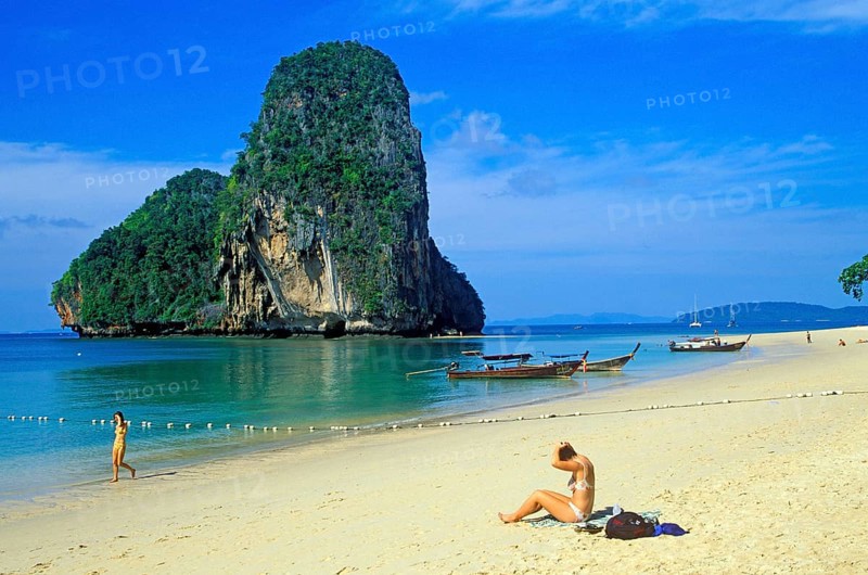 Rocks in the sea, people and longtail boats on Pranang Cave beach, two years in front of the tsunami, Krabi, Thailand, December 2002, vintage, retro, old, historic