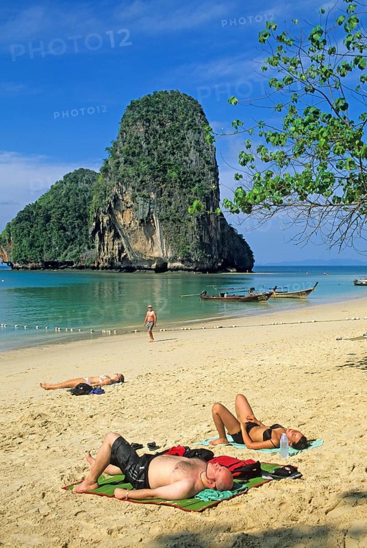 Rocks in the sea, people and longtail boats on Pranang Cave beach, two years in front of the tsunami, Krabi, Thailand, December 2002, vintage, retro, old, historic