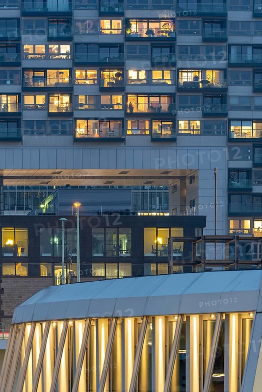 The lights of the Imhoff Chocolate Museum, behind them the illuminated façade of Kranhaus Nord, Rheinauhafen, Cologne, North Rhine-Westphalia, Germany