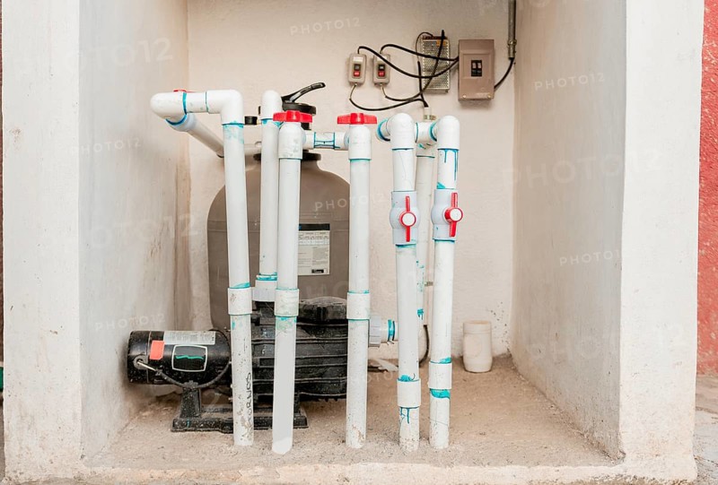 Pool pump with sand filter installed. Pool purification and maintenance system. Home pool filter and treatment plant installed