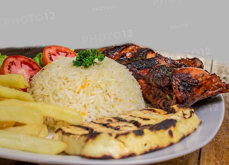 Pork rib with rice, fried cheese and salad served on the table, Close up of Pork rib with salad and French fries served on wooden table, Top view of plate of fresh Pork rib served on the table