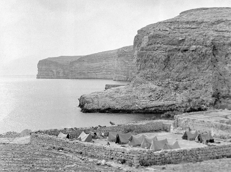 Military tents at walled campsite overlooking sea cliffs at Xlendi Bay, Island of Gozo, Malta, Europe, 1956