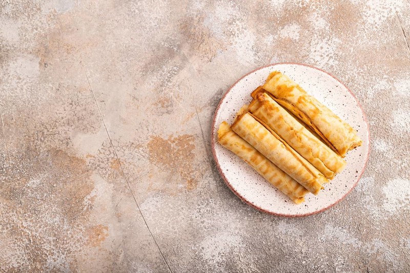 Waffles with caramel on brown concrete background, top view, flat lay, copy space