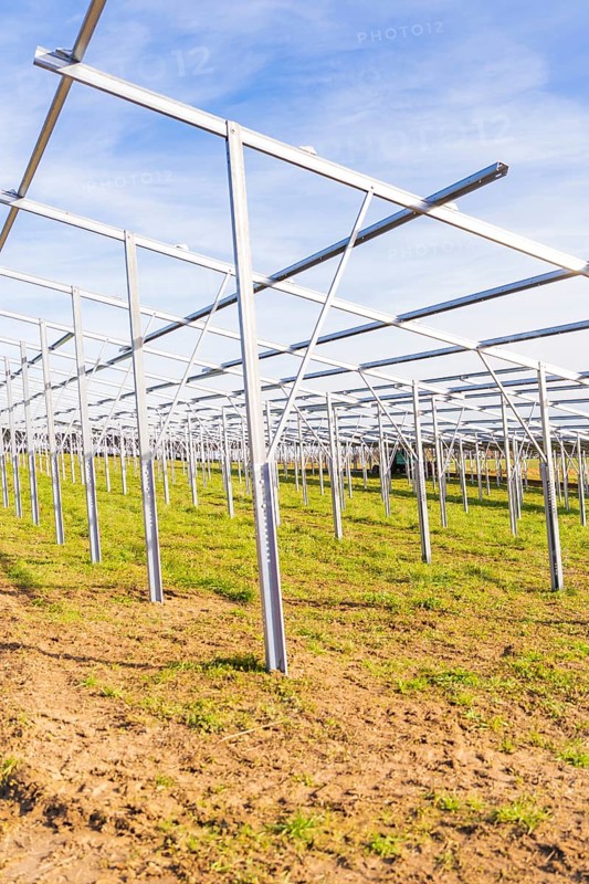 Empty metal frames on a field under a blue sky, Energiewende, construction of PV open space, Baden-Württemberg, Germany