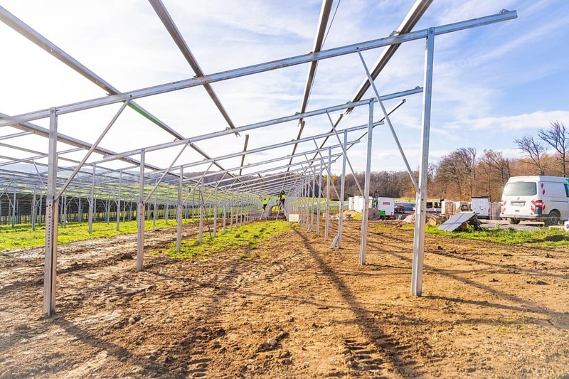 Unfinished solar system in open area with vehicles and building materials, energy transition, construction of PV open space, Baden-Württemberg, Germany