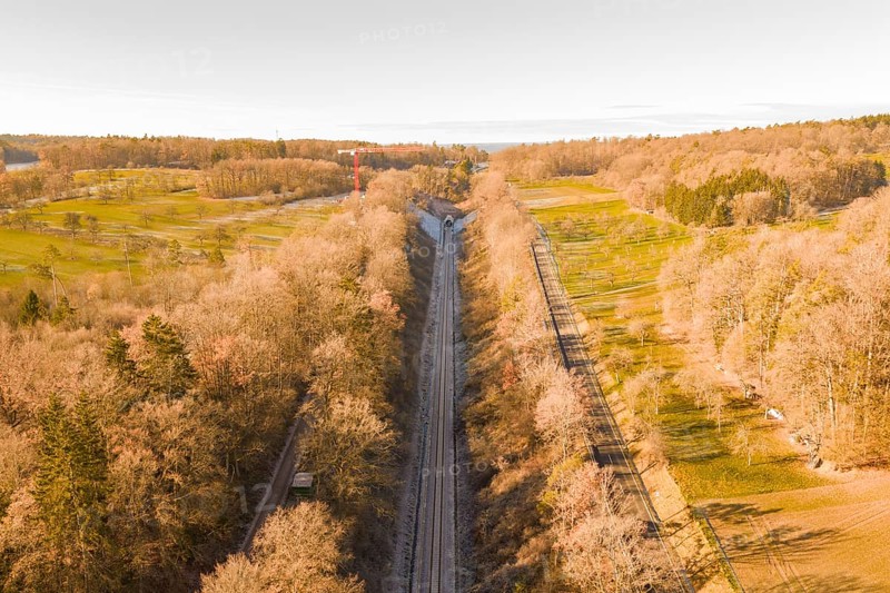 Train route from above, flanked by autumnal forests, running through nature, construction of the Hermann Hesse Railway, Calw, Germany
