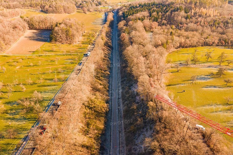 A railway cuts through fields and forests in a wintry countryside landscape, construction of the Hermann Hesse Railway, Calw, Germany