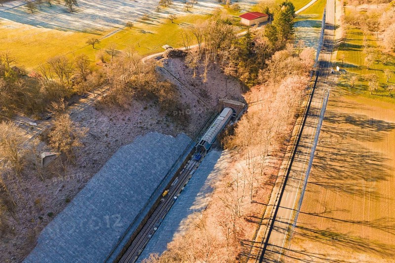 Drone view of a railway line through an autumn landscape with meadows and forests, construction of the Hermann Hesse Railway, Calw, Germany
