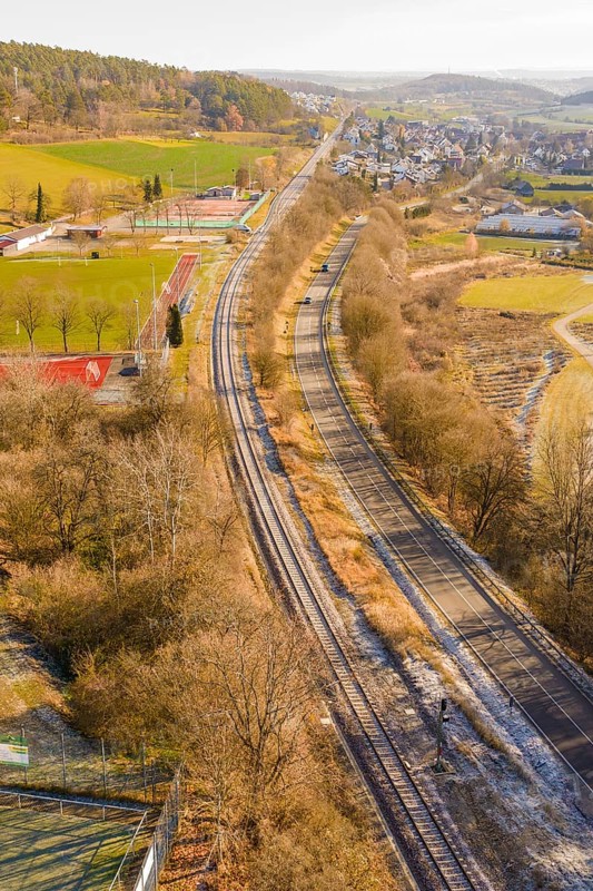Rails and roads in a rural area with an adjacent village, construction of the Hermann Hesse Railway, Calw, Germany
