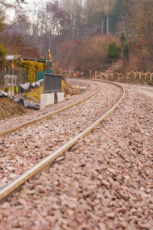 Railway tracks on a bend surrounded by gravel, along a wintry landscape, construction of the Hermann Hesse Railway, Calw, Germany