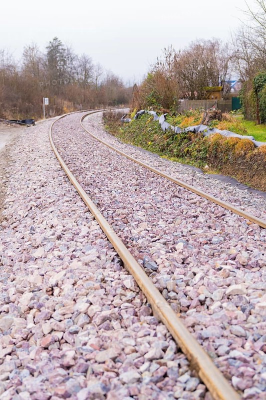 Close-up of a winding railway line with rails and gravel, construction of the Hermann Hesse Railway, Calw, Germany
