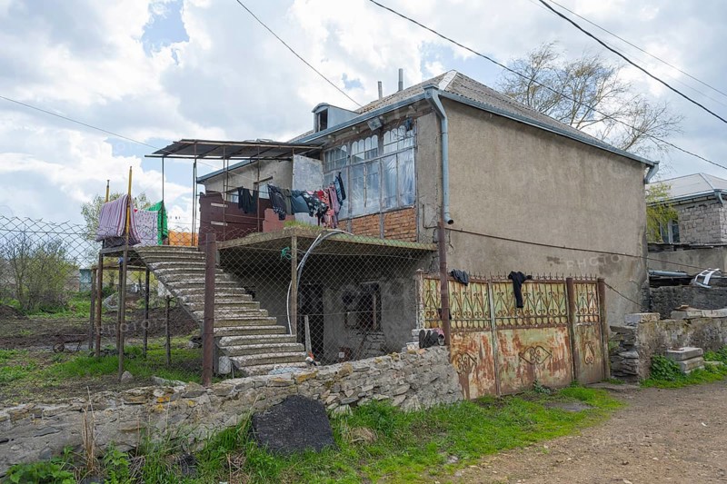 Rural building with external staircase, suspended clothing and adjacent wall, inhabited house, Sameba, Kvemo Kartli region, Lower Kartli, Georgia