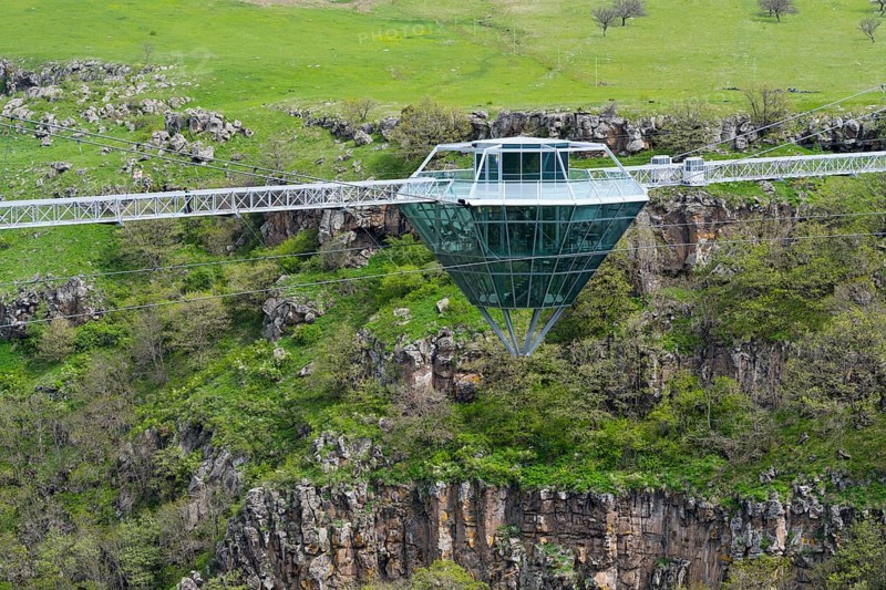 A glass bridge floats over a rocky and green gorge, Diamond Glass Bridge, world's longest free-hanging structure, Dashbashi Gorge, Khrami River, Chrami, Tsalka Nature Reserve, Kartli, Georgia