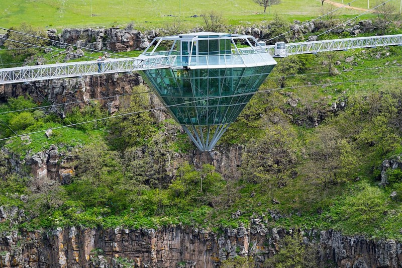 Modern glass bridge crosses green gorge with trees and rocks, diamond bridge, Diamond Glass Bridge, world's longest free-hanging structure, Dashbashi Gorge, Khrami River, Tsalka Nature Reserve, Kartli, Georgia