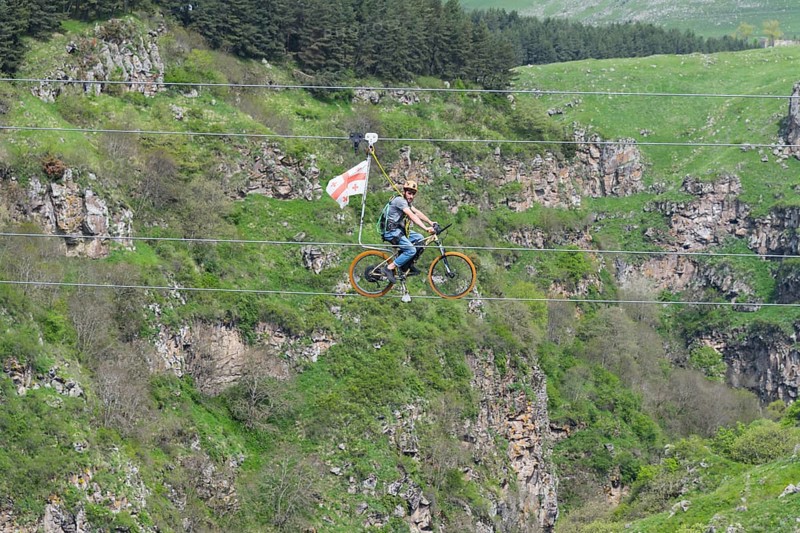 Adventurous bicycle ride on a rope through a distinctive rocky landscape, Dashbashi Gorge, Khrami River, Tsalka Nature Reserve, Kartli, Georgia